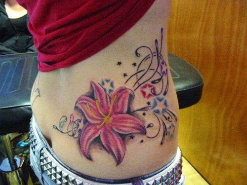 Beautiful Color Stars And Lily Flower Tattoo On Lower Back