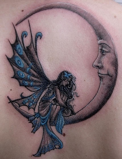 Black And Blue Gothic Fairy On Half Moon Tattoo On Upper Back