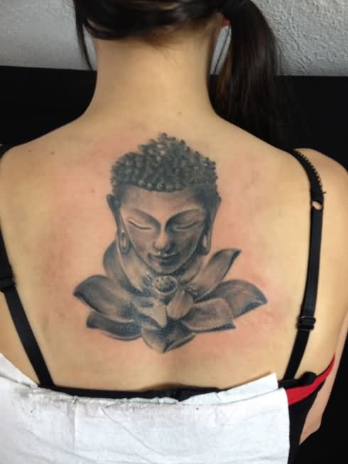 Black And Grey Buddha Head With Lotus Flower Tattoo On Girl Upper Back