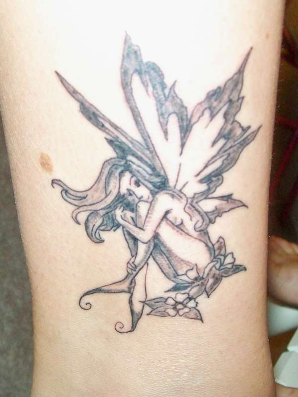 Black And Grey Fairy On Flowers Tattoo Design For Ankle