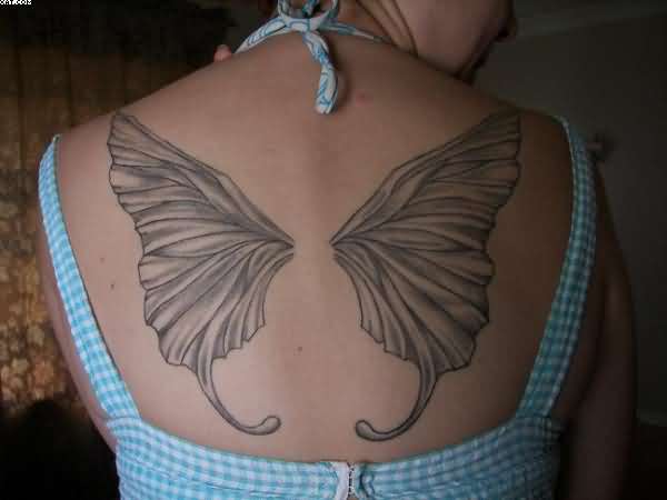 Black And Grey Fairy Wings Tattoo On Women Upper Back