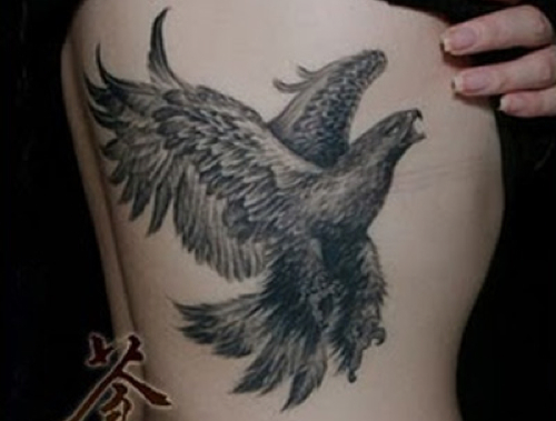 Black And Grey Flying Eagle Tattoo On Right Side Rib