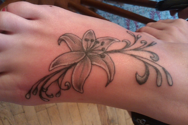 Black And Grey Lily Flower Tattoo On Girl Right Foot
