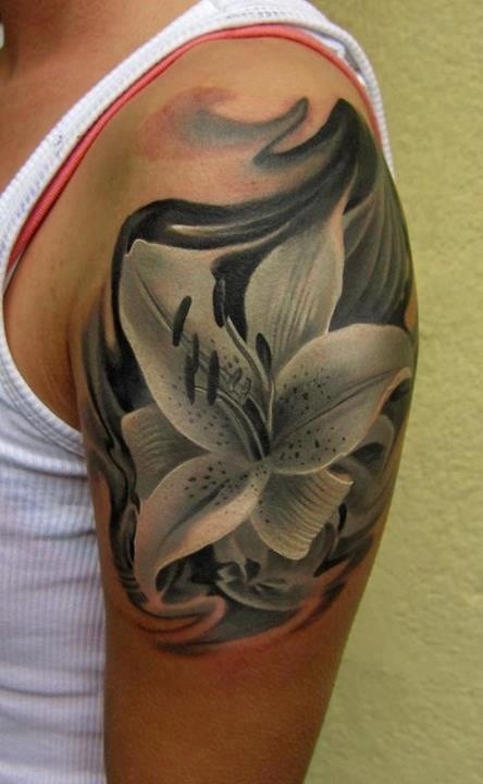 Black And Grey Lily Flower Tattoo On Left Shoulder