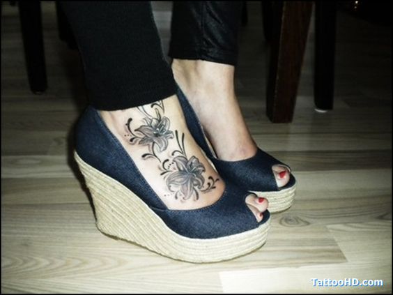 Black And Grey Lily Flowers Tattoo On Right Foot