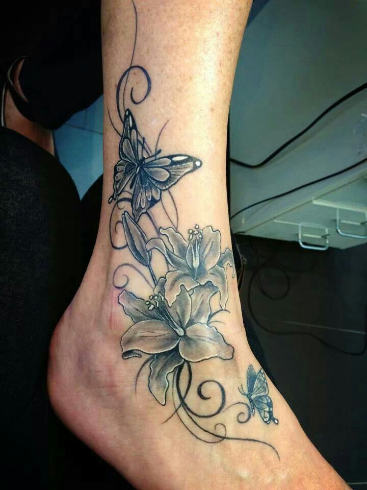 Black And Grey Lily Flowers With Butterfly Tattoo On Right Ankle