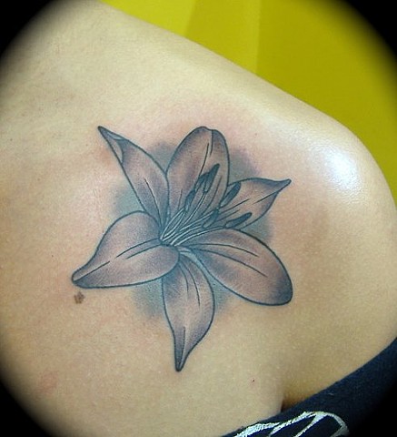 Black And Grey Lily Tattoo On Front Shoulder