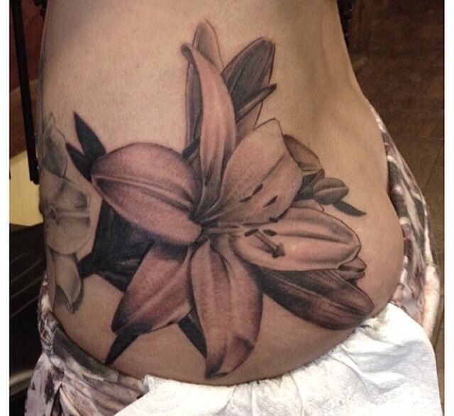 Black And Grey Lily Tattoo On Side Rib
