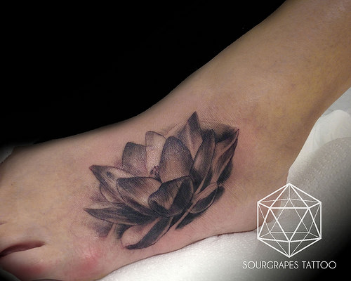 Black And Grey Lotus Flower Tattoo On Foot