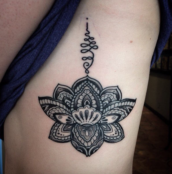 Black And Grey Lotus Flower Tattoo On Man Left Side Rib