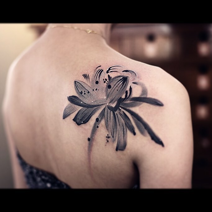 Black And Grey Lotus Flower Tattoo On Right Back Shoulder