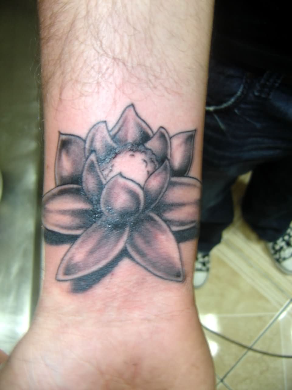 Black And Grey Lotus Flower Tattoo On Wrist