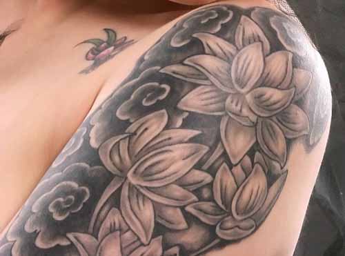 Black And Grey Lotus Flowers Tattoo On Man Left Half Sleeve