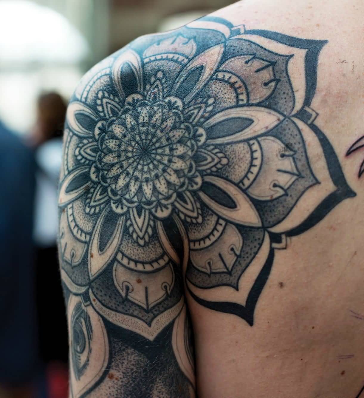 Black And Grey Mandala Lotus Tattoo On Man Left Back Shoulder