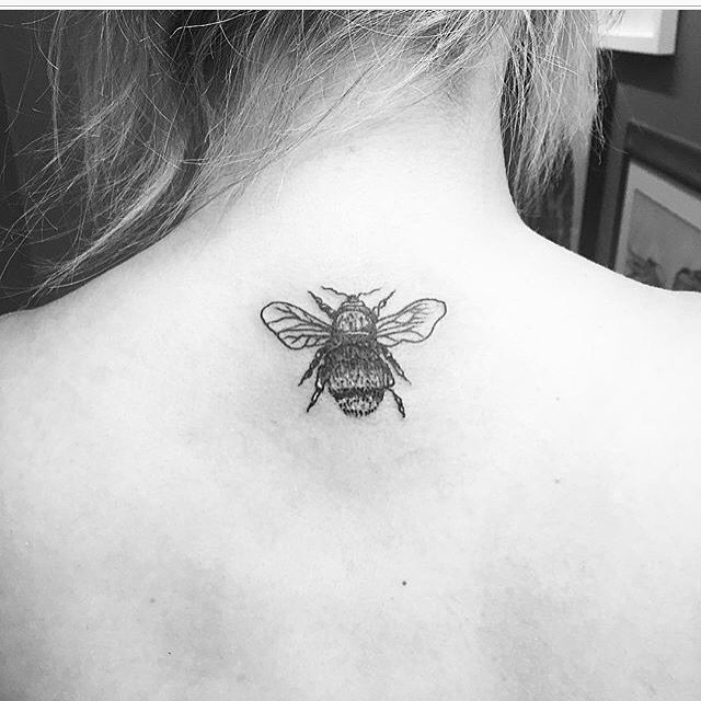 Black And White Bumblebee Tattoo On Women Back Neck