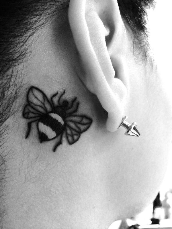Black Bumblebee Tattoo On Right Behind The Ear