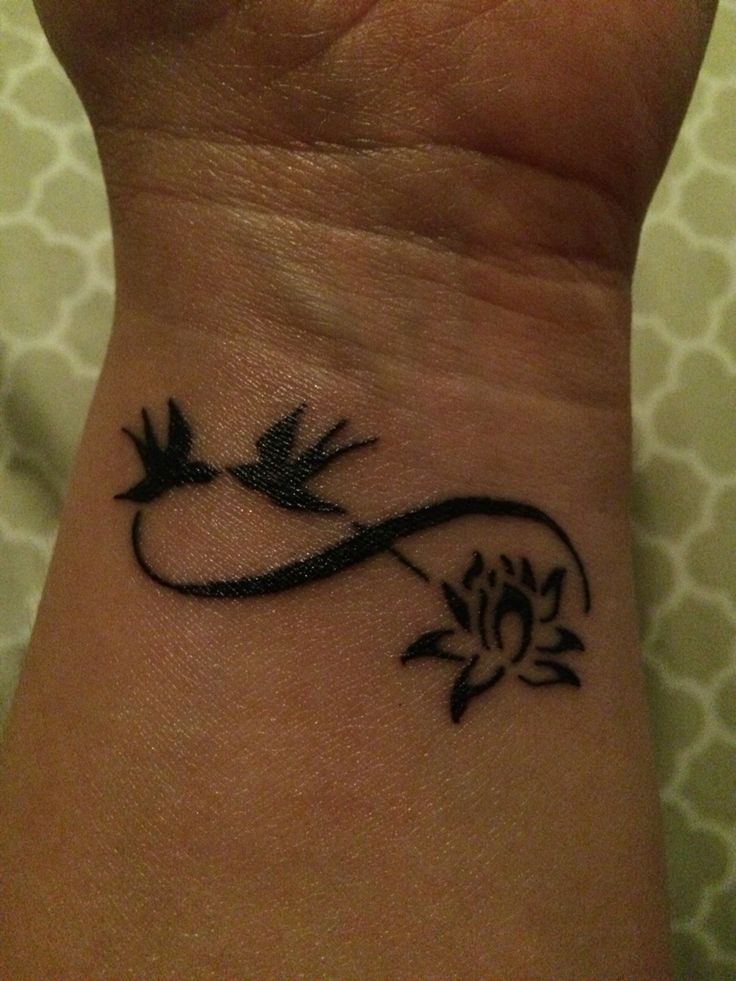 Black Infinity With Lotus Flower And Flying Birds Tattoo On Wrist