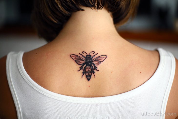 Black Ink Bumblebee Tattoo On Women Upper Back