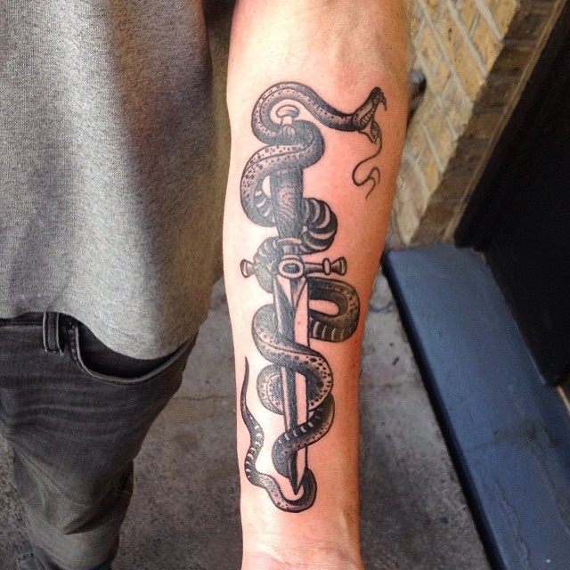 Black Ink Dagger With Snake Tattoo On Left Forearm