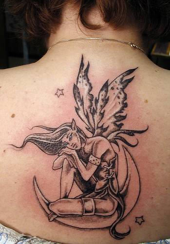Black Ink Fairy On Half Moon Tattoo On Girl Upper Back