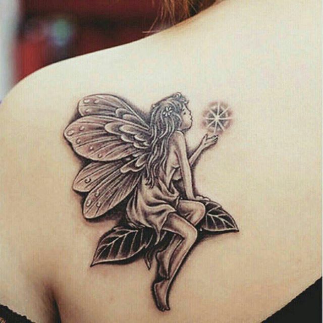 Black Ink Fairy On Leaves Tattoo On Girl Left Back Shoulder