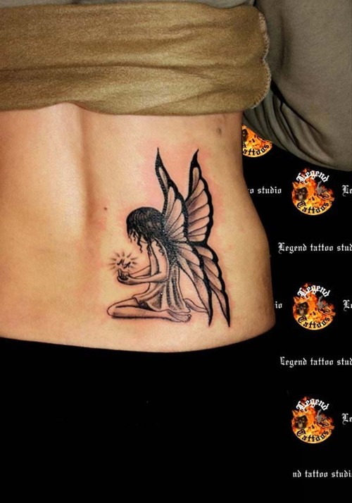 Black Ink Fairy Tattoo On Girl Lower Back