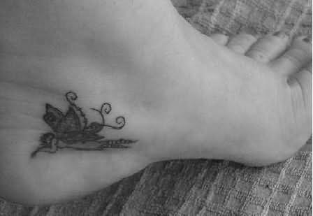 Black Ink Fairy Tattoo On Left Foot Ankle