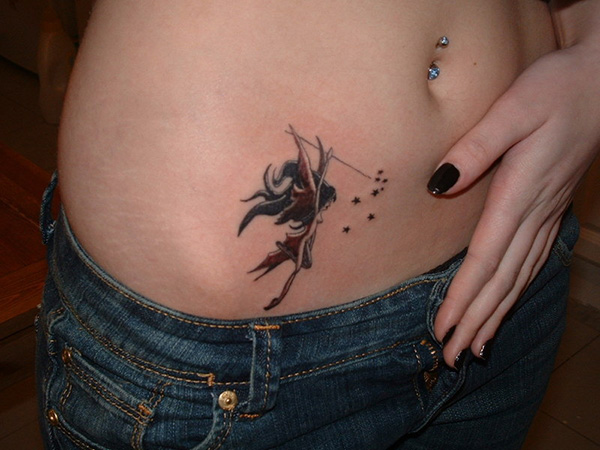 Black Ink Fairy With Fairy Dust Tattoo On Girl Waist