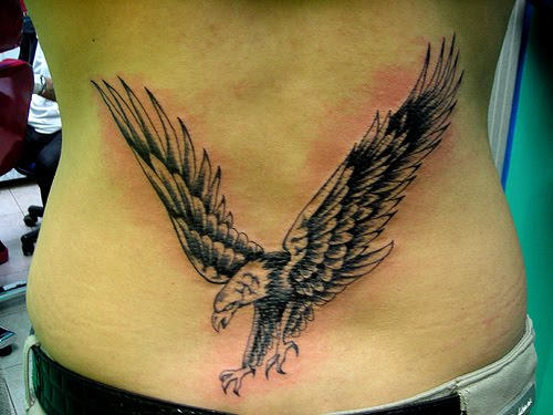 Black Ink Flying Eagle Tattoo On Man Lower Back