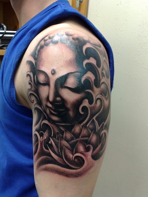 Black Ink Girl Face With Lotus Flower Tattoo On Man Left Upper Arm