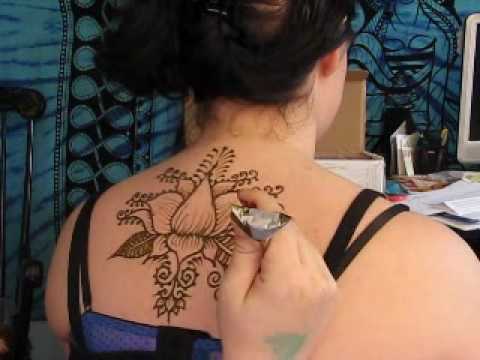 Black Ink Henna Lotus Flower Tattoo On Girl Upper Back