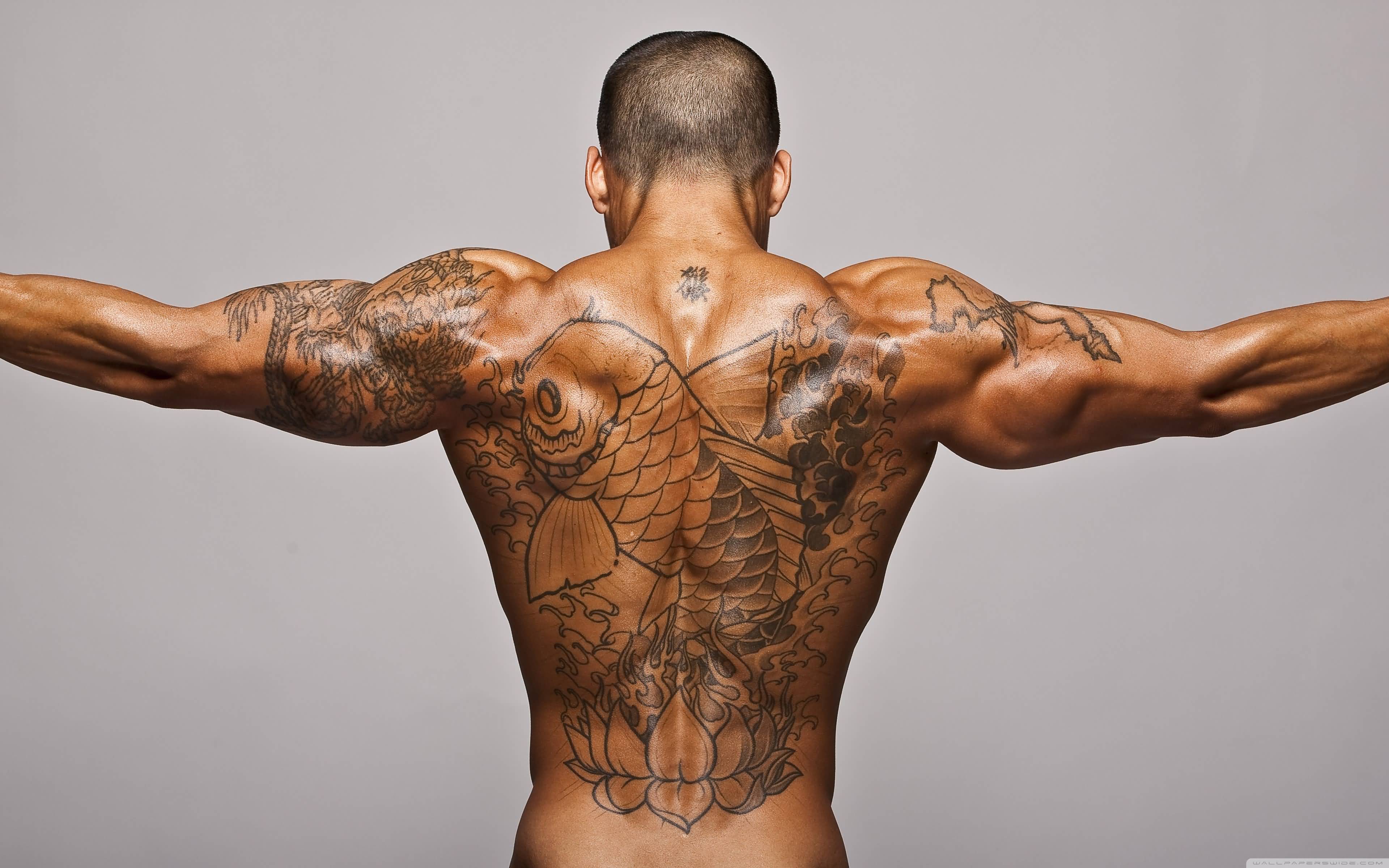 Black Ink Koi Fish With Lotus Flower Tattoo On Man Full Back