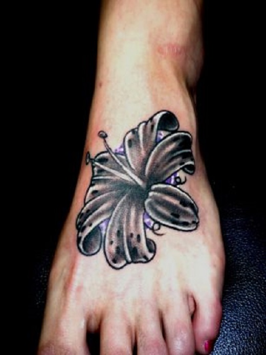 Black Ink Lily Flower Tattoo On Left Foot