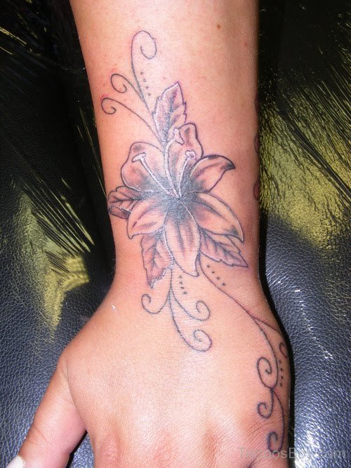 Black Ink Lily Flower Tattoo On Left Upper Wrist