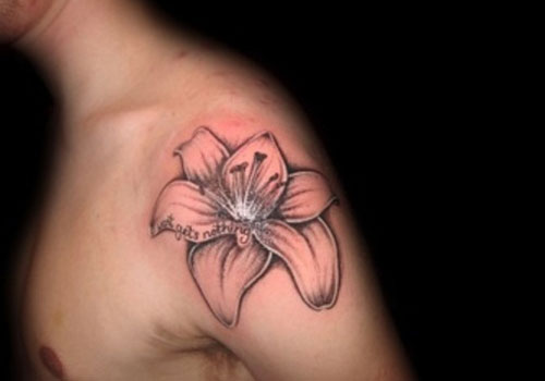 Black Ink Lily Flower Tattoo On Man Left Shoulder
