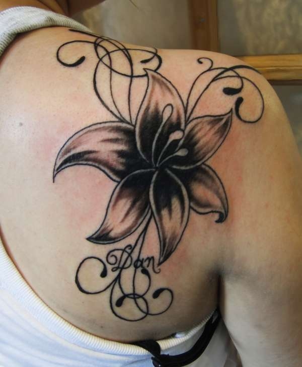 Black Ink Lily Flower Tattoo On Right Back Shoulder