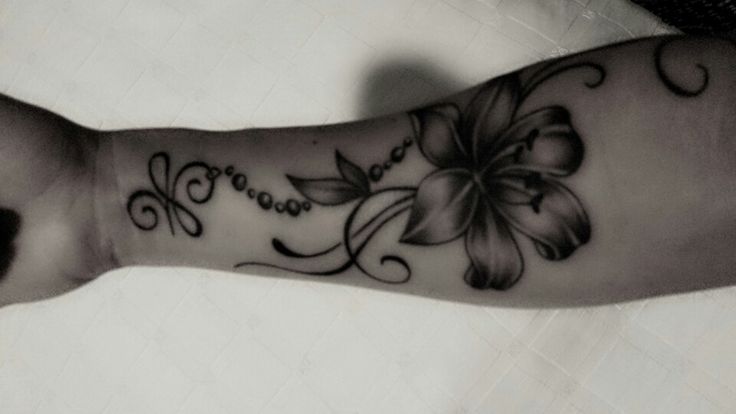 Black Ink Lily Flower Tattoo On Right Forearm