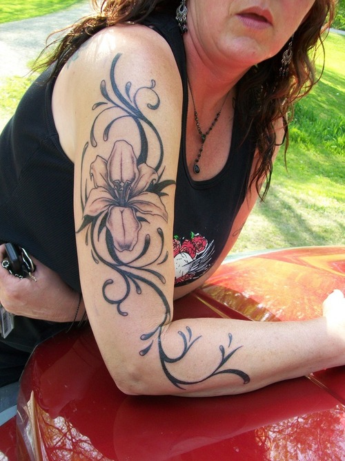 Black Ink Lily Flower Tattoo On Women Right Half Sleeve