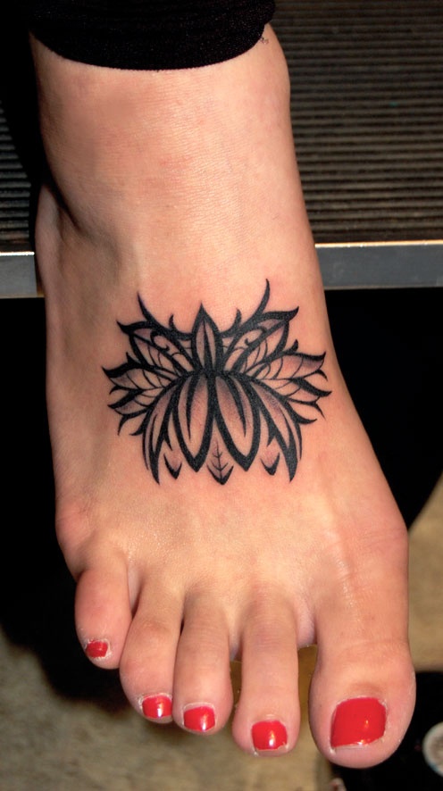 Black Ink Lotus Flower Tattoo On Girl Right Foot