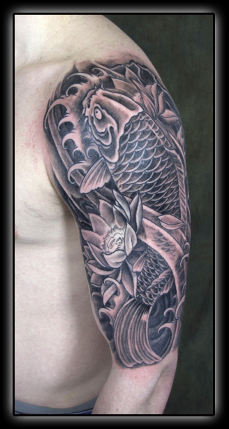 Black Ink Lotus Flower With Koi Fish Tattoo On Man Left Upper Arm