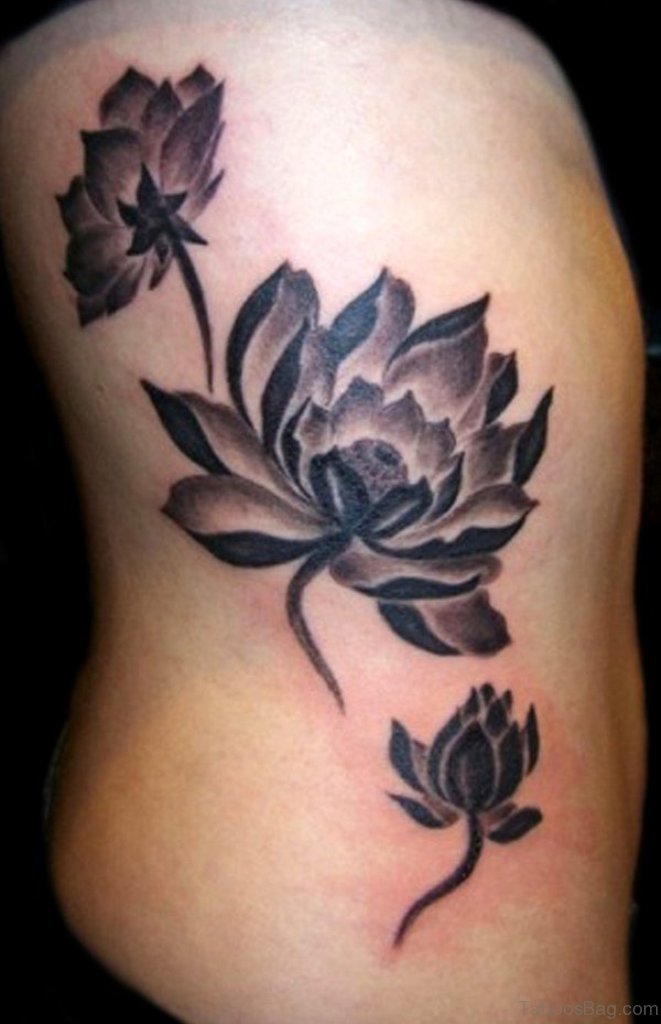 Black Ink Lotus Flowers Tattoo On Right Side Rib