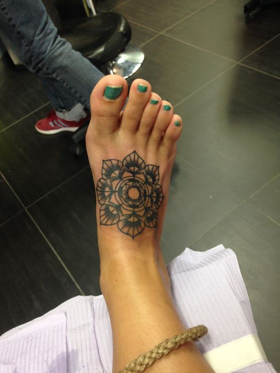Black Ink Mandala Lotus Flower Tattoo On Girl Right Foot