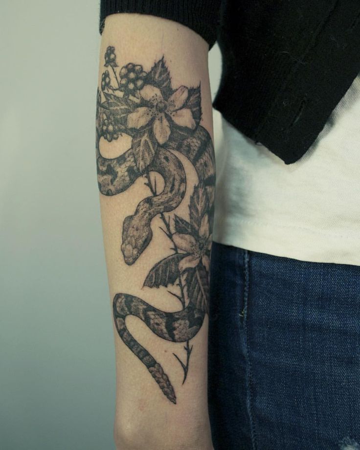 Black Ink Rattlesnake With Flowers Tattoo On Right Arm