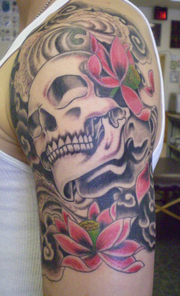 Black Ink Skull With Lotus Flowers Tattoo On Left Half Sleeve