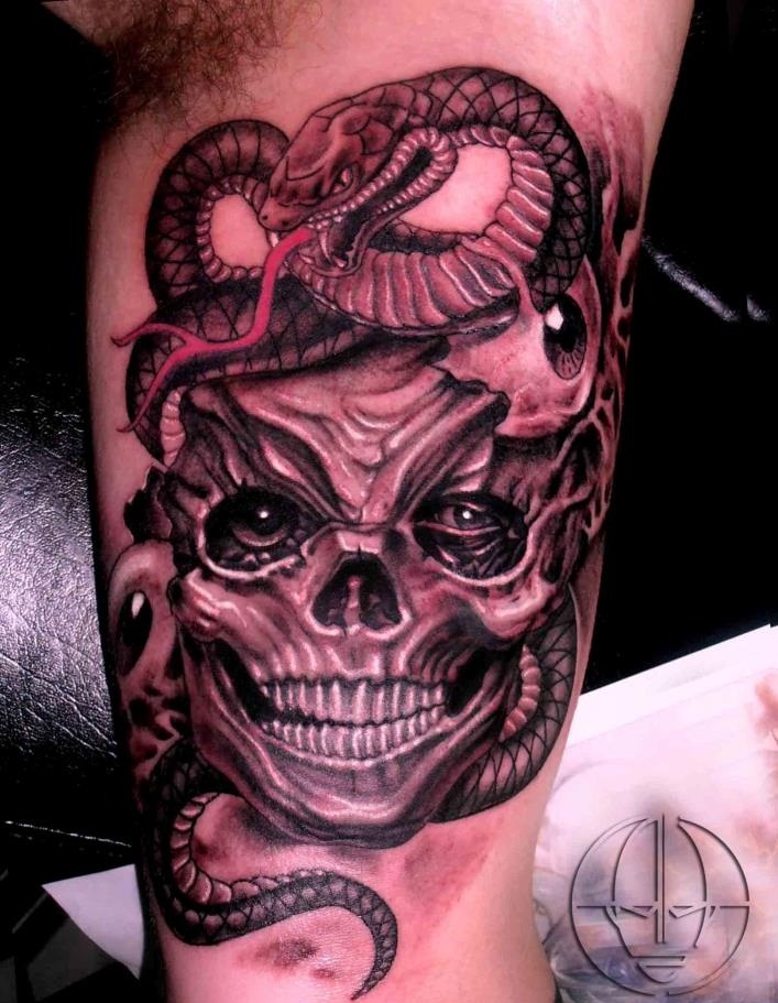 Black Ink Skull With Snake Tattoo On Bicep