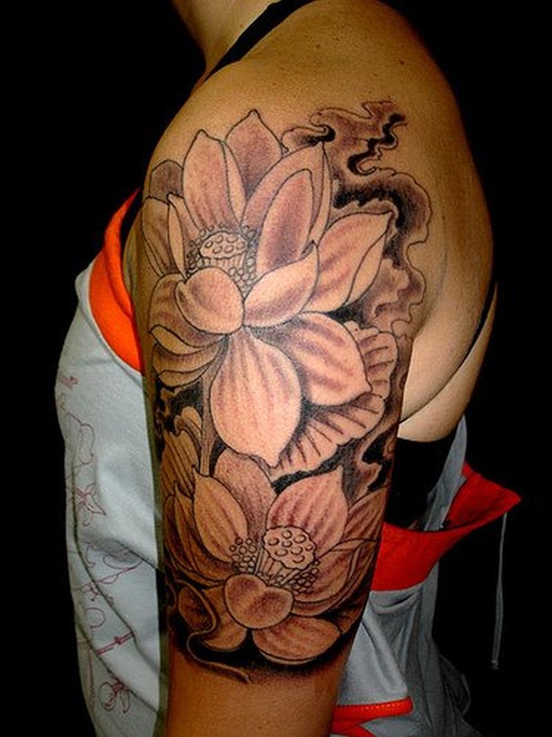 Black Ink Small Lotus Flowers Tattoo On Left Half Sleeve