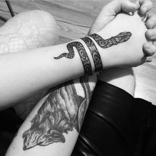Black Ink Snake Tattoo On Girl Wrapped Around Arm