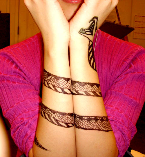 Black Ink Snake Tattoo On Girl Wrapped Around Both Arm