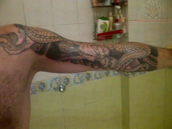 Black Ink Snake Tattoo On Man Left Half Sleeve