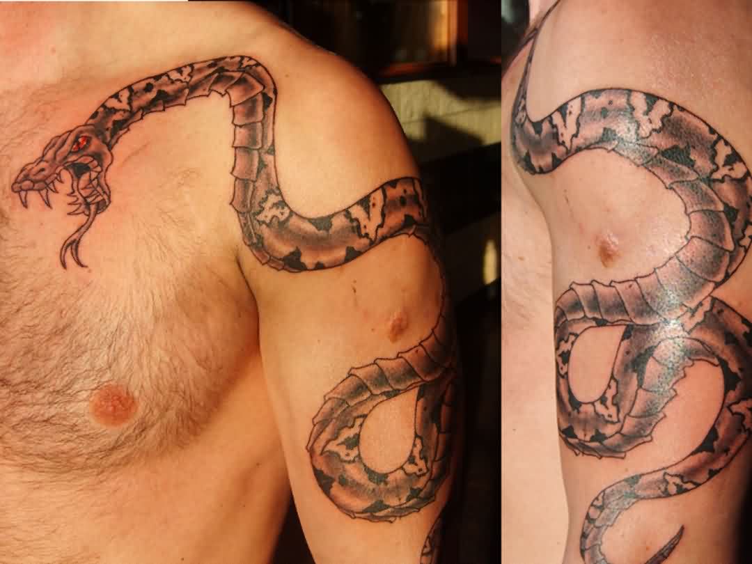 Black Ink Snake Tattoo On Man Left Upper Arm.